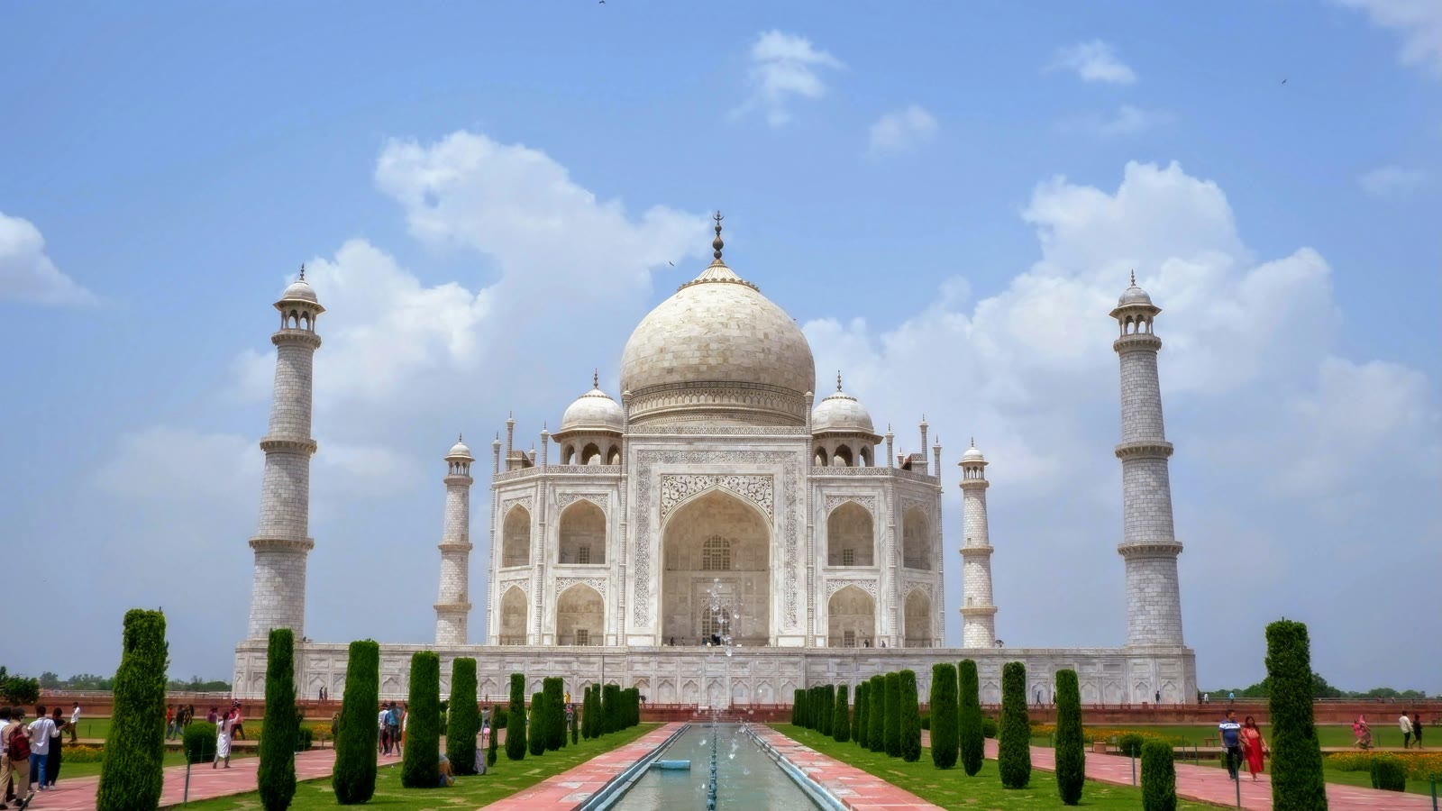 Taj Mahal white marble mausoleum under blue sky in Agra, India