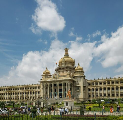 Modern Bangalore cityscape with high-rise buildings and busy urban streets under clear sky
