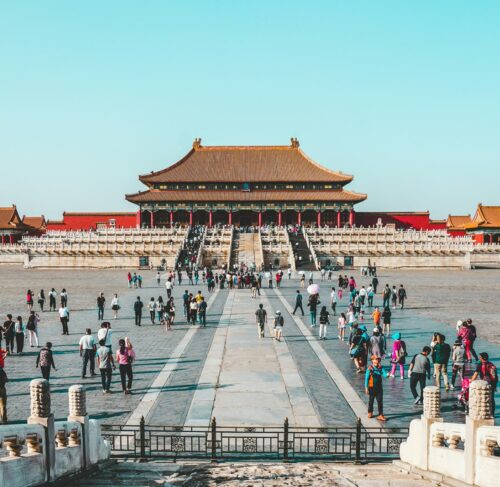 Forbidden City in Beijing China viewed from above with crowds of visitors on a clear day
