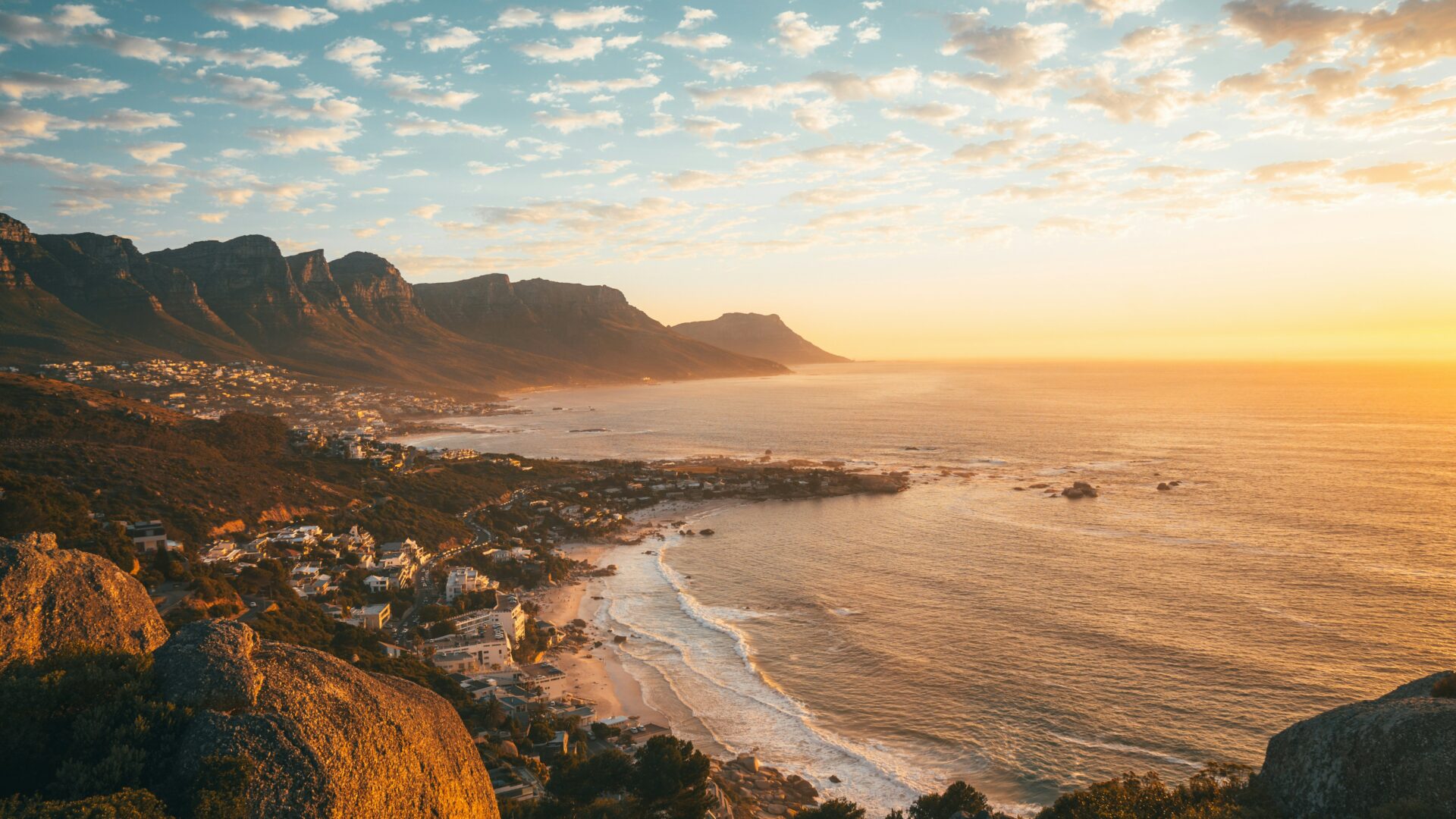 Brown rocky mountain beside the sea during daytime in Cape Town