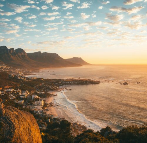 Brown rocky mountain beside the sea during daytime in Cape Town