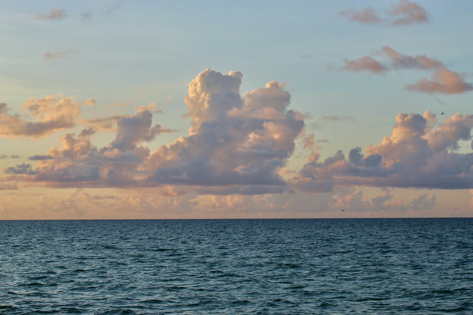 Wide expanse of calm water under cloudy sky at Chuburná beach, Yucatán