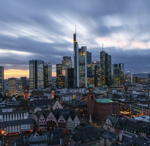 Frankfurt skyline with modern skyscrapers under white clouds during daytime