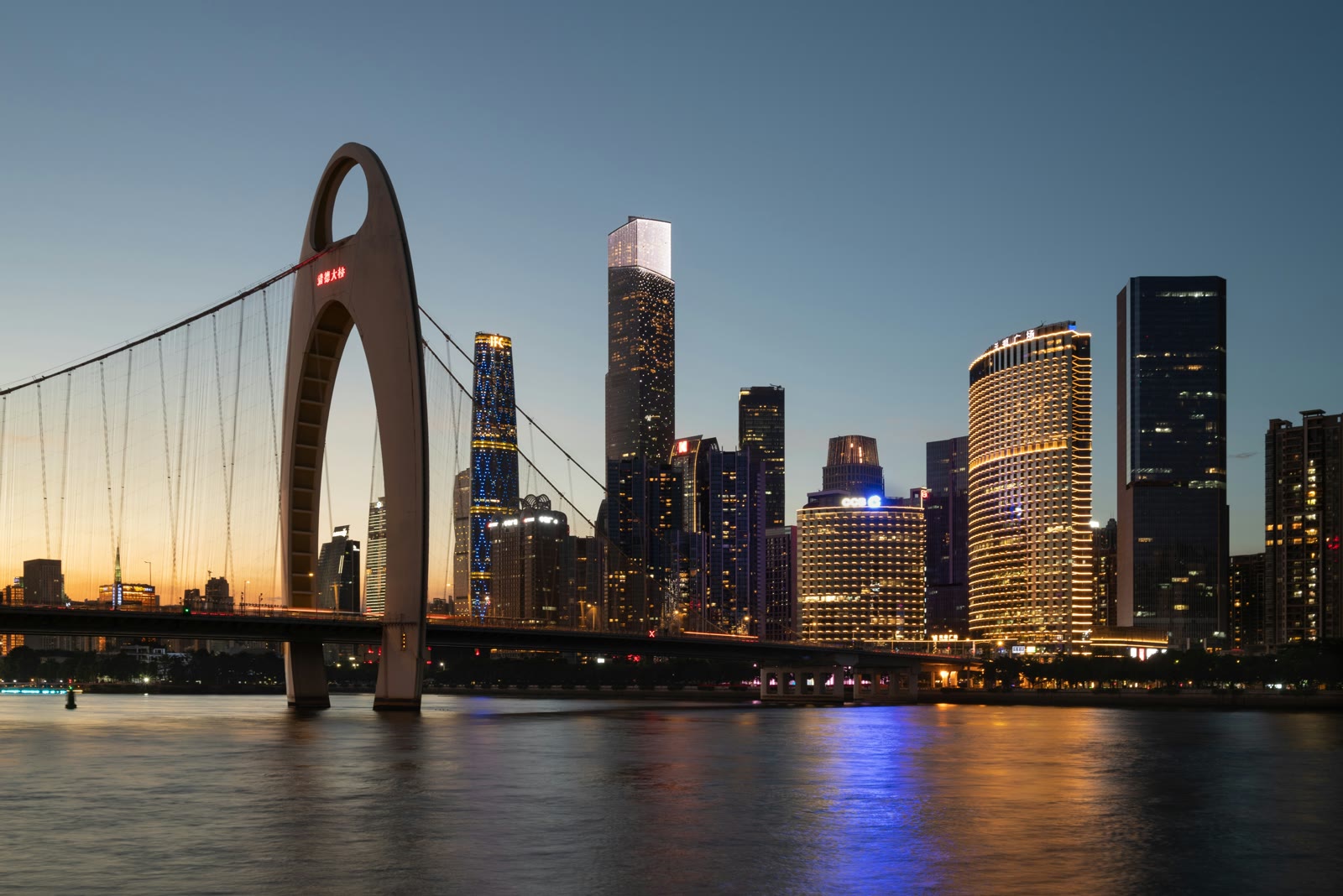 Guangzhou skyline at night with illuminated Canton Tower and city lights reflecting on the Pearl River