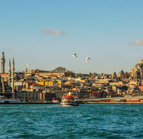 Istanbul skyline along the Bosphorus waterway with mosques and city buildings on a sunny day