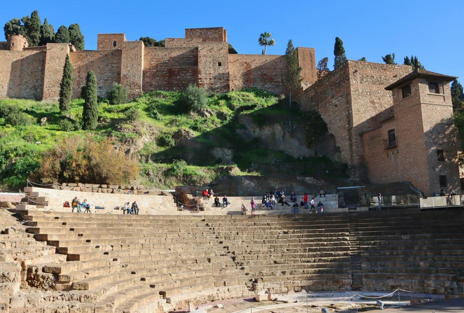 Malaga Alcazaba hill fortress on lush green hillside in Andalusia Spain