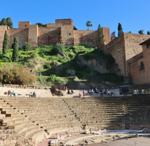 Malaga Alcazaba hill fortress on lush green hillside in Andalusia Spain