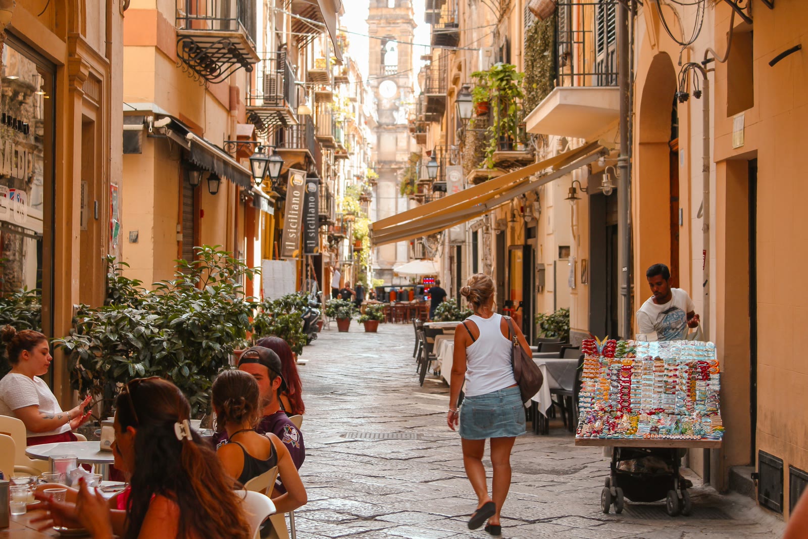 Woman walking on a narrow street in Palermo Sicily old town with historic buildings