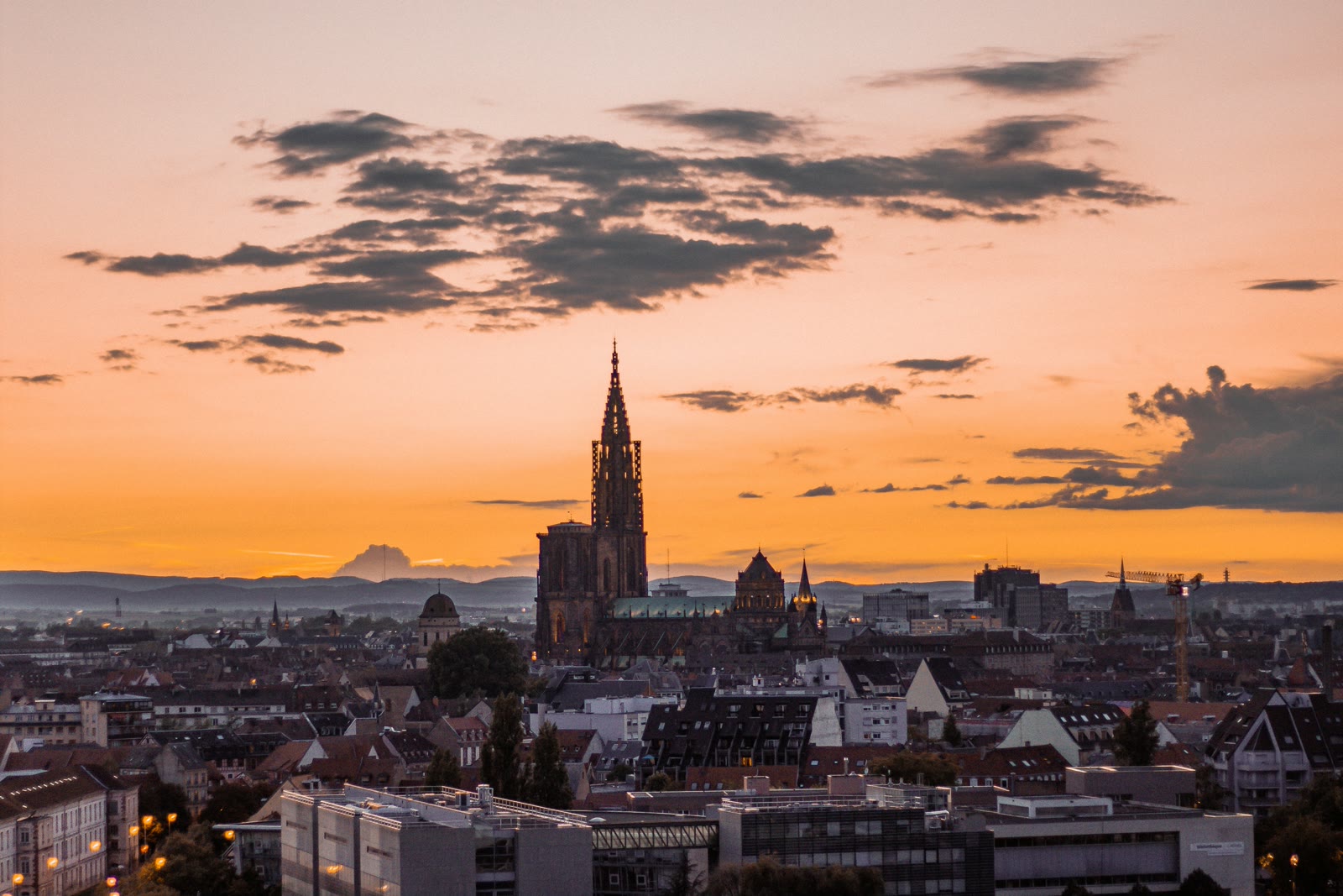 Strasbourg Petite France district at sunset with River Ill and half-timbered buildings under orange sky