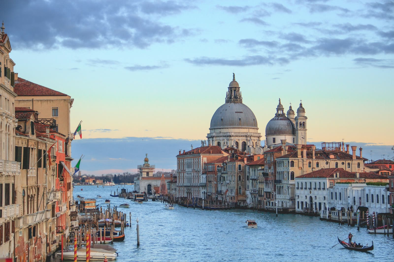Aerial view of Venice canals and historic buildings under blue sky, Italy