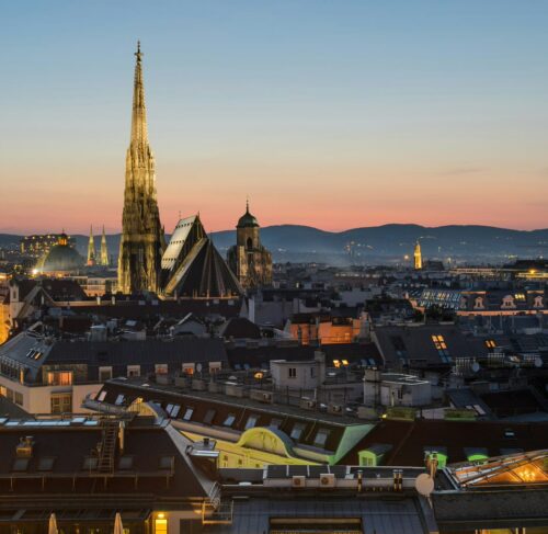 Aerial view of Vienna city center with historic buildings, St. Stephen's Cathedral spire, and the Ringstrasse boulevard layout visible from above