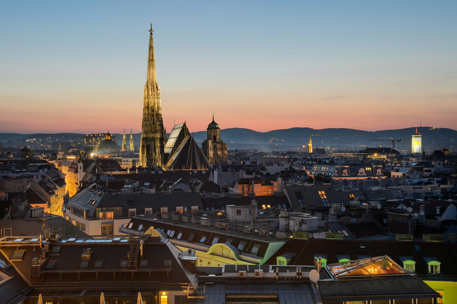 Aerial view of Vienna city center with historic buildings, St. Stephen's Cathedral spire, and the Ringstrasse boulevard layout visible from above