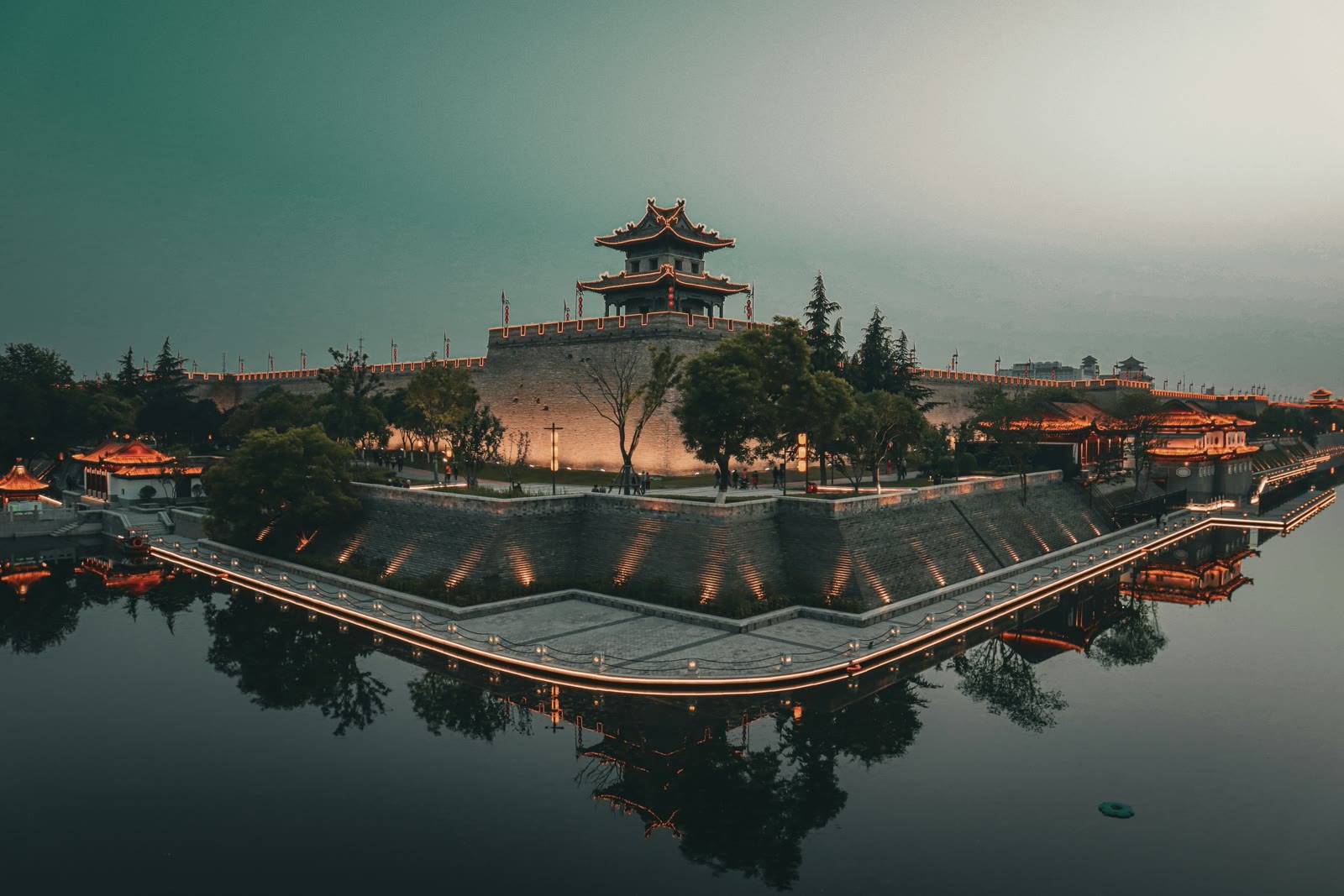 Giant Wild Goose Pagoda in Xi'an China, ancient Buddhist temple with water reflection and modern skyline behind