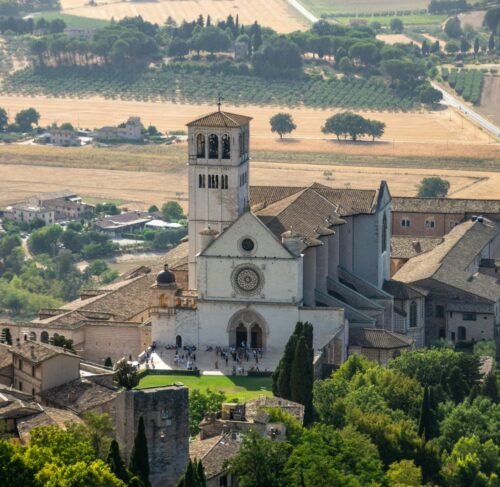 White and brown stone building in Assisi, Umbria, Italy