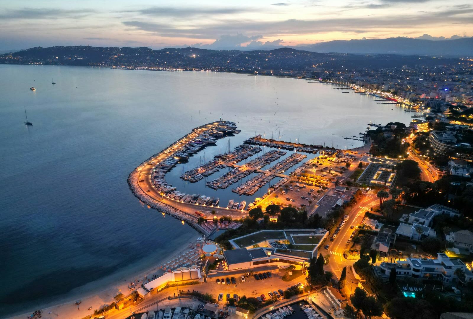 Aerial view of Cannes marina and harbor with La Croisette at night, French Riviera, France