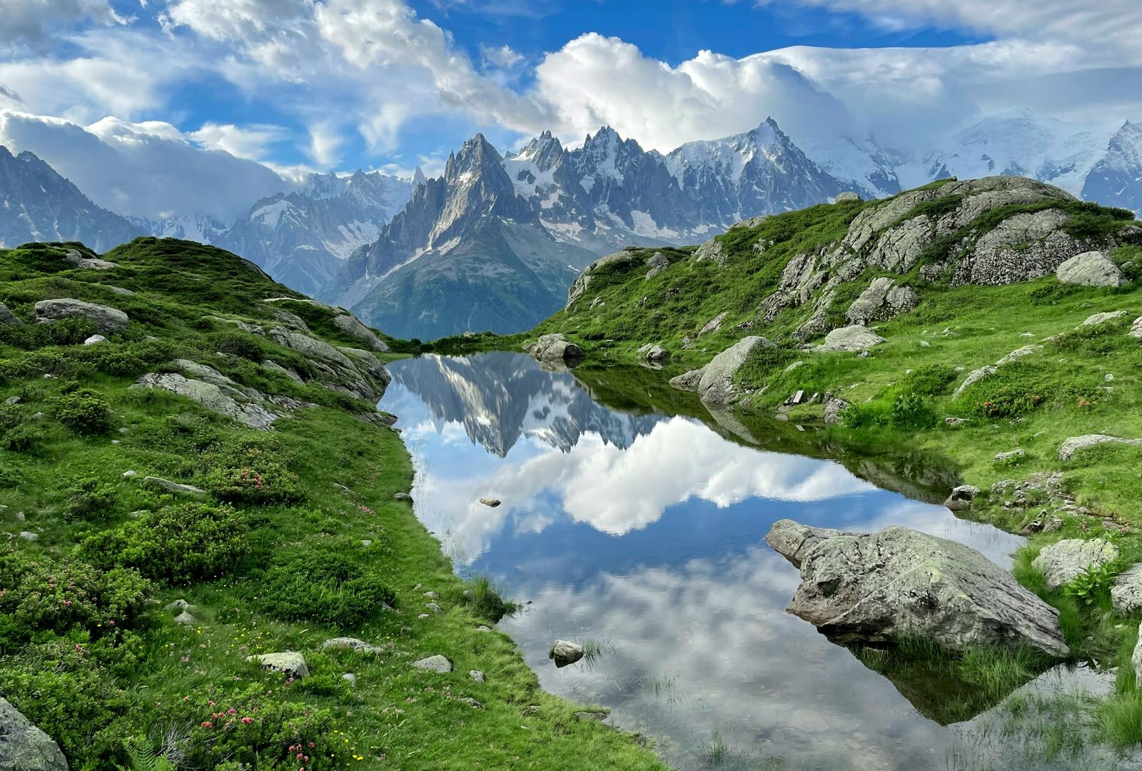 Mountain lake surrounded by grass and rocks in Chamonix, Auvergne-Rhone-Alpes, France