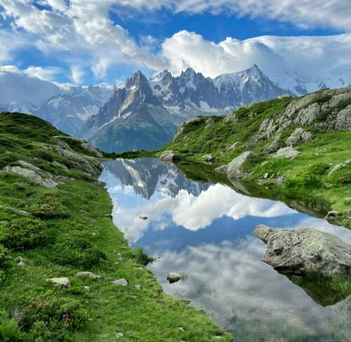 Mountain lake surrounded by grass and rocks in Chamonix, Auvergne-Rhone-Alpes, France