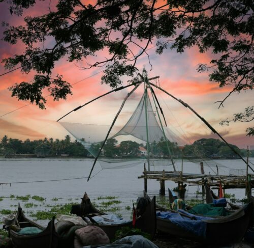 Fishing boats at sunset in Kochi harbor, Kerala, India