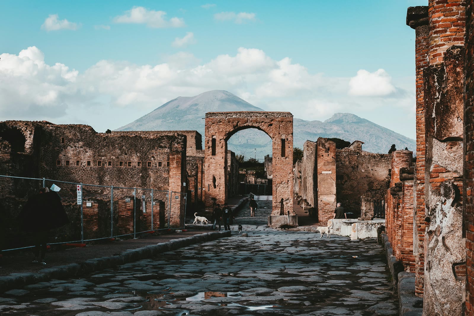 Ancient Pompeii ruins with stone arch and Mount Vesuvius in Campania, Italy