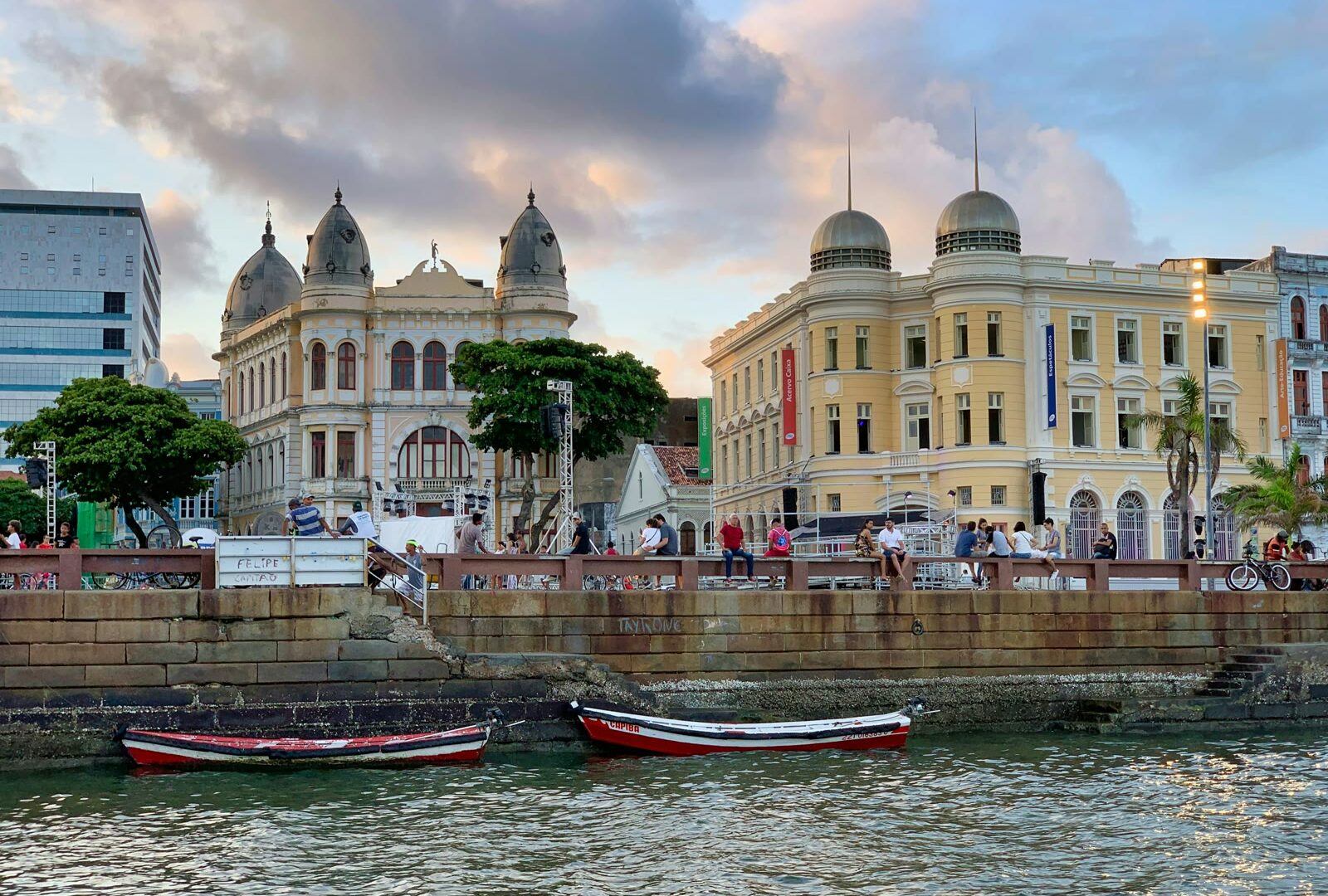 Red and white boat on the water near buildings in Recife, Pernambuco, Brazil