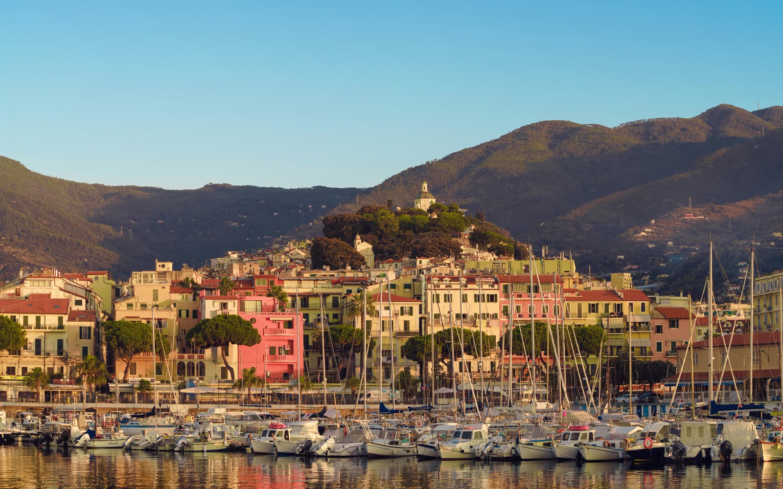 Harbor full of boats with mountains behind, Sanremo, Liguria, Italy