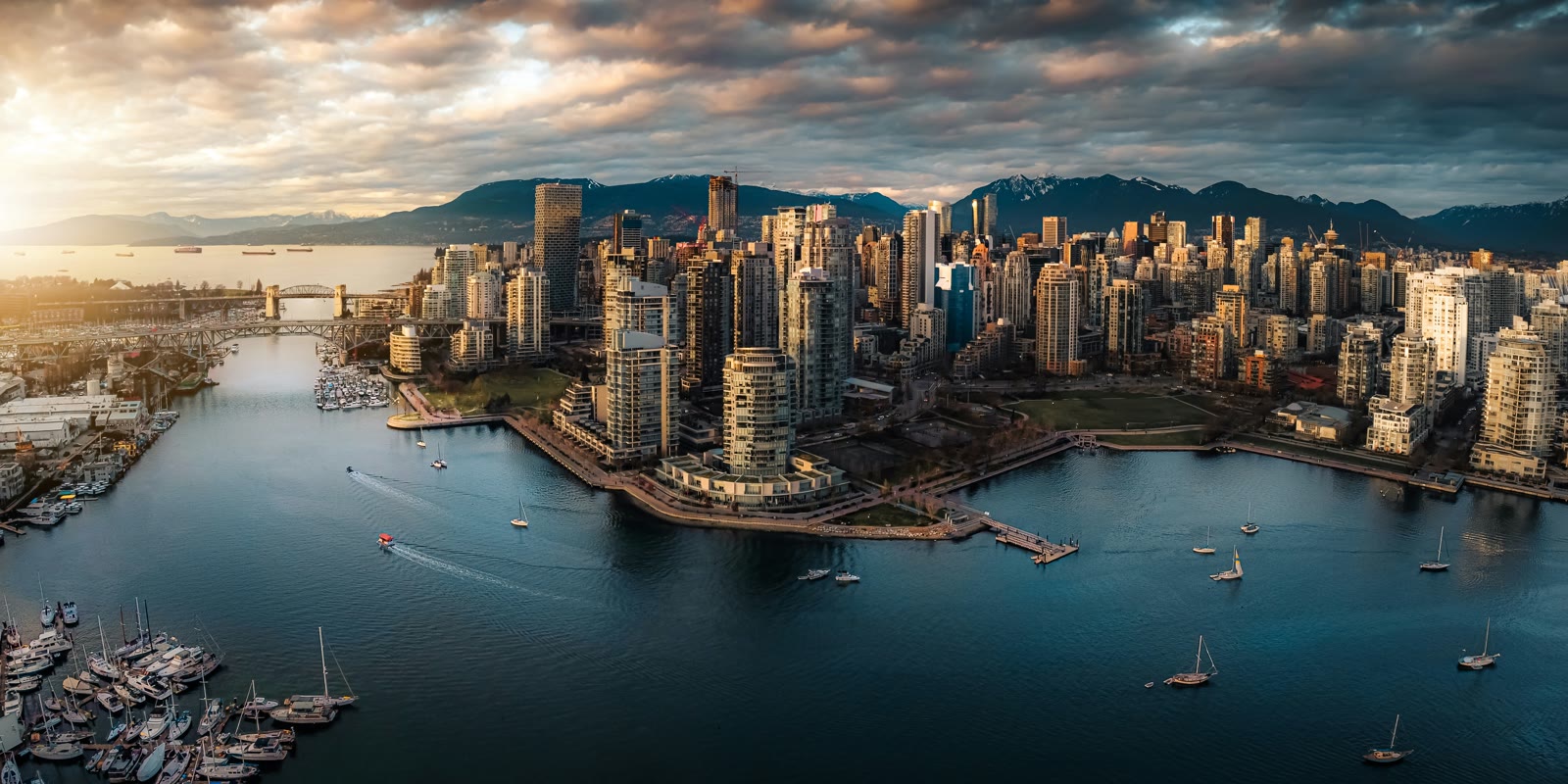 Aerial view of Vancouver city skyline and harbor with water and mountains, British Columbia, Canada