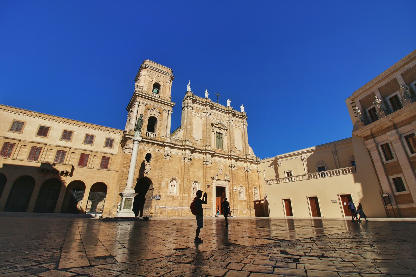 People standing in front of a building in Brindisi, Apulia, Italy