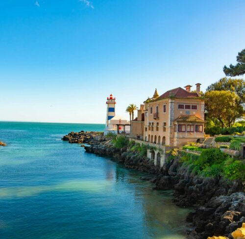 White and brown building by the water in Cascais, Lisbon, Portugal