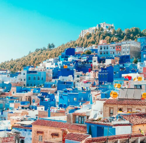 Blue and white painted houses on cliff in Chefchaouen, Morocco