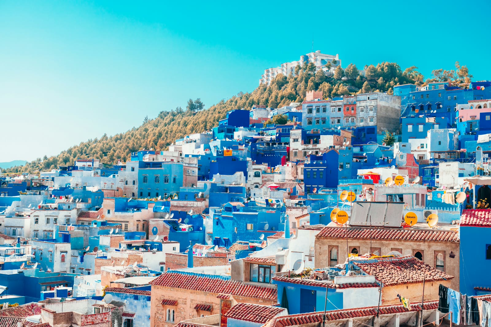 Blue and white painted houses on cliff in Chefchaouen, Morocco