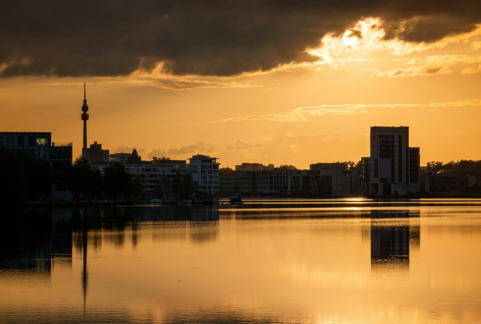 Sun setting over a city and body of water in Dortmund, North Rhine-Westphalia, Germany