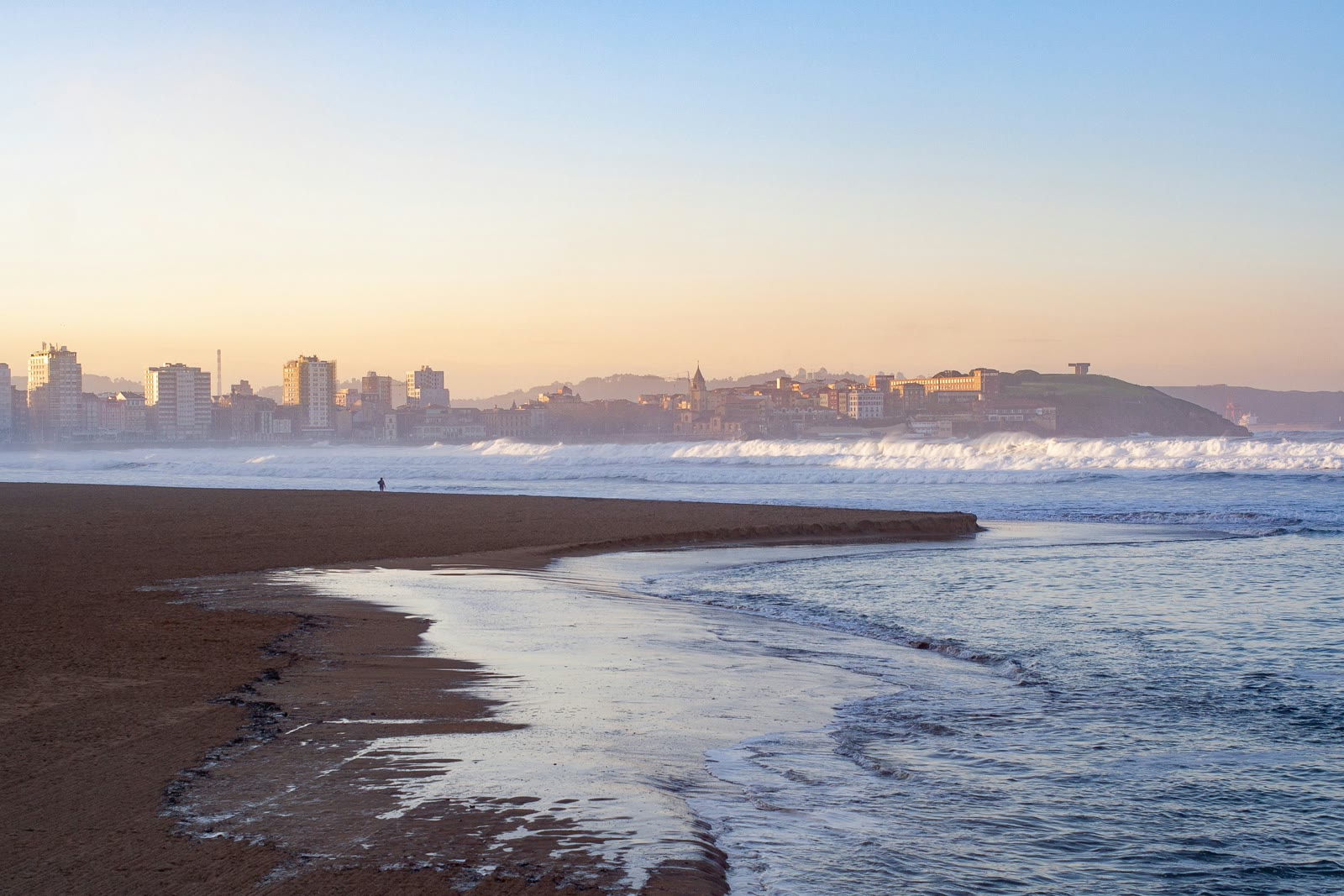 Waves crashing onto the shore in Gijon, Asturias, Spain