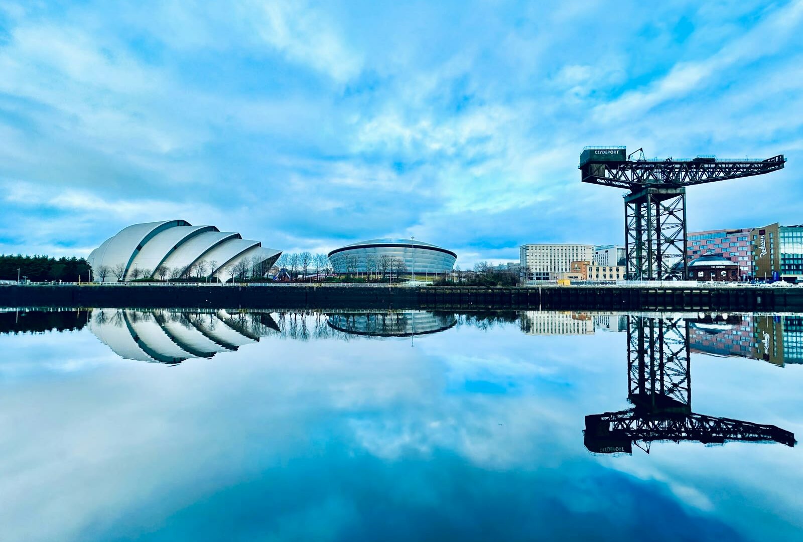 Large body of water with a building in background in Glasgow, Scotland, UK