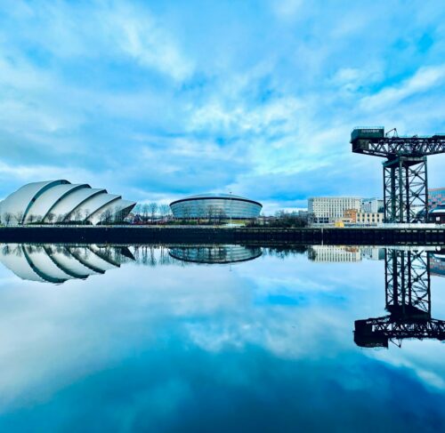 Large body of water with a building in background in Glasgow, Scotland, UK