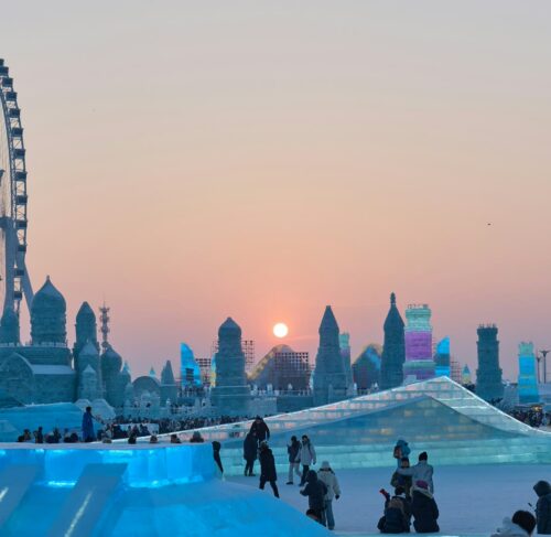 People standing around an ice sculpture in Harbin, Heilongjiang, China
