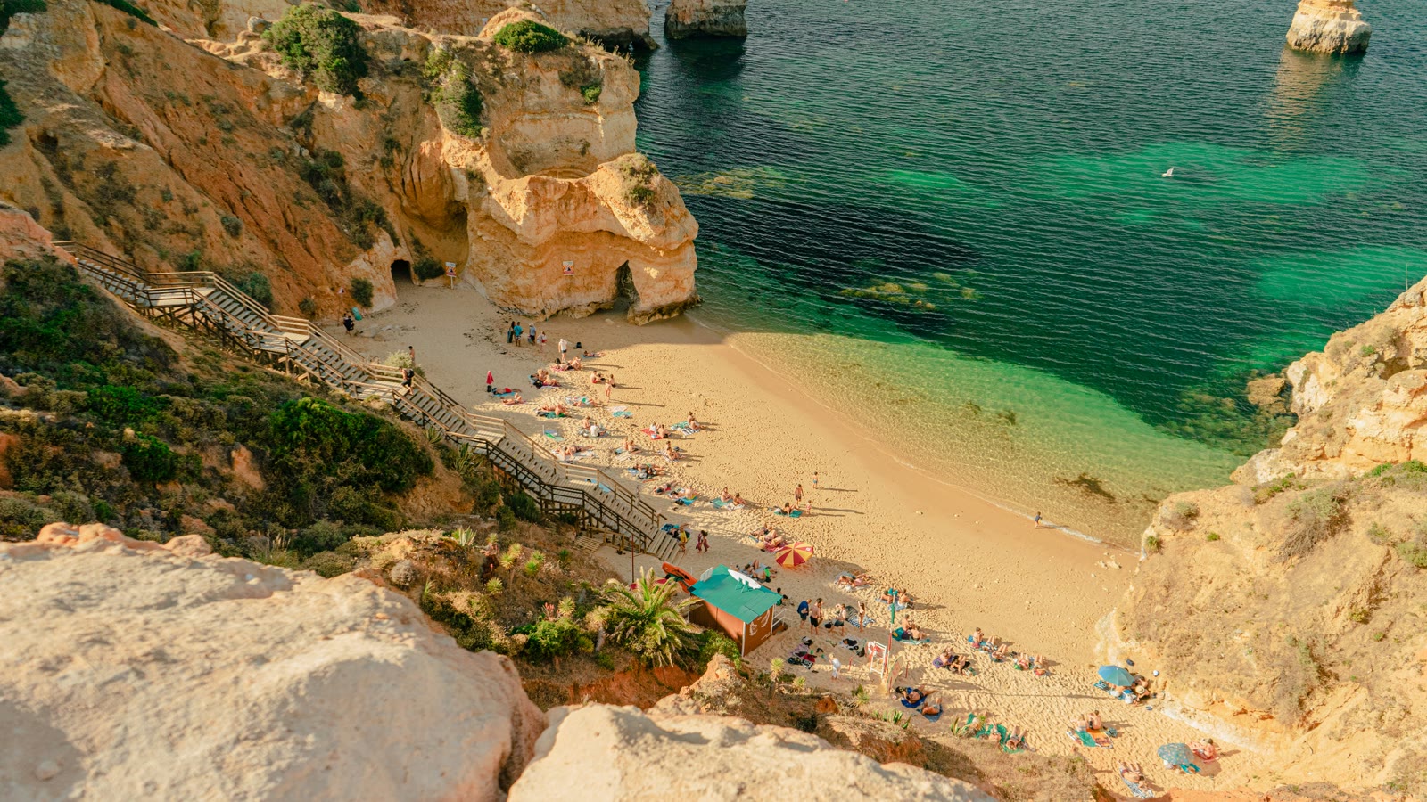 People on the beach during the day in Lagos, Algarve, Portugal