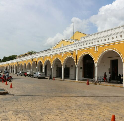 Arched colonial building with parking in Merida, Yucatan, Mexico
