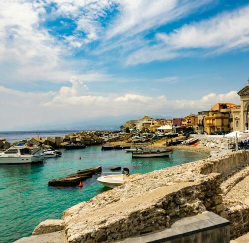 White boat on the beach in Messina, Sicily, Italy
