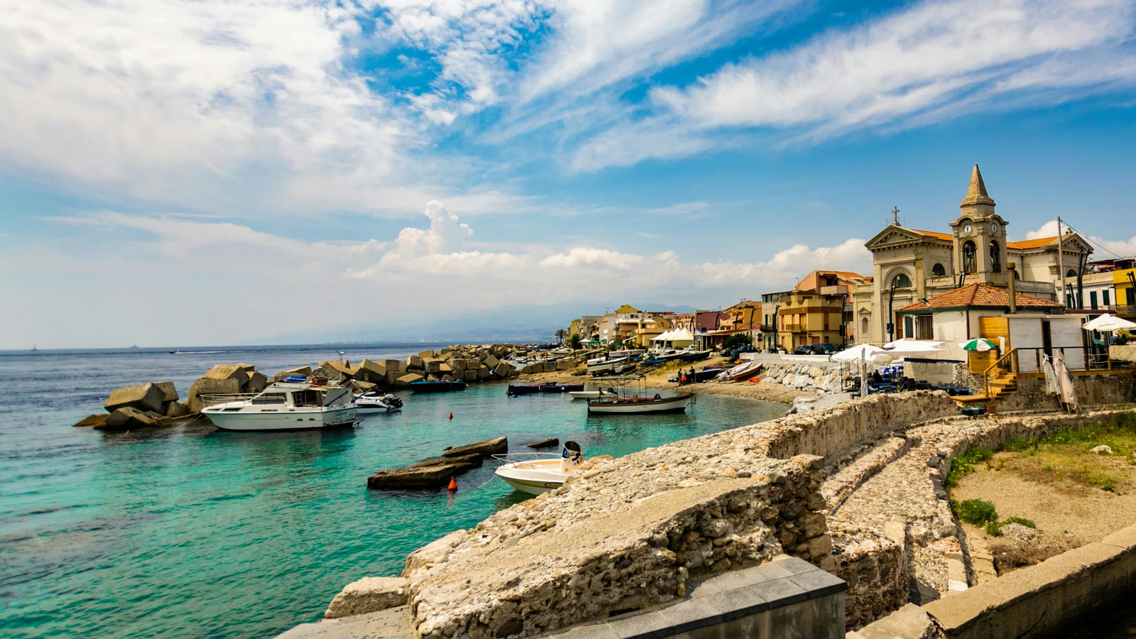White boat on the beach in Messina, Sicily, Italy