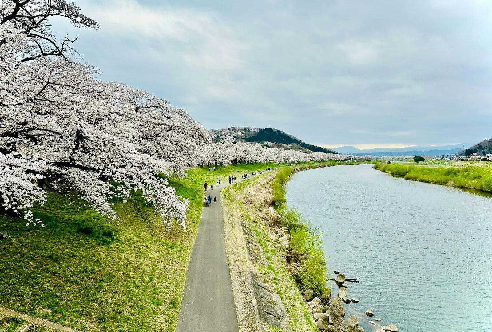 People walking along a riverside path in Sendai, Miyagi, Japan