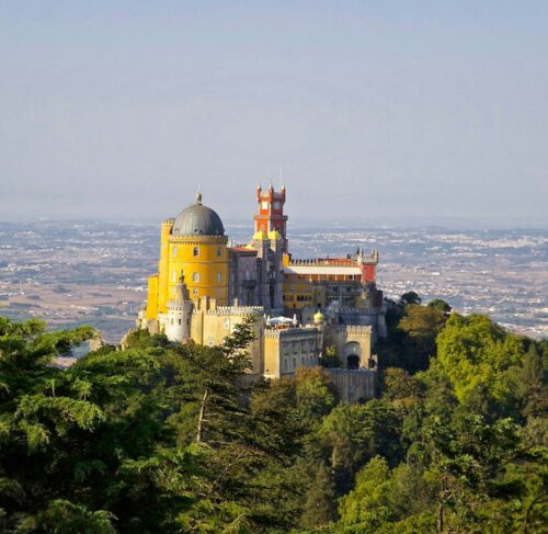 Yellow and grey Pena Palace on a hilltop in Sintra, Lisbon, Portugal