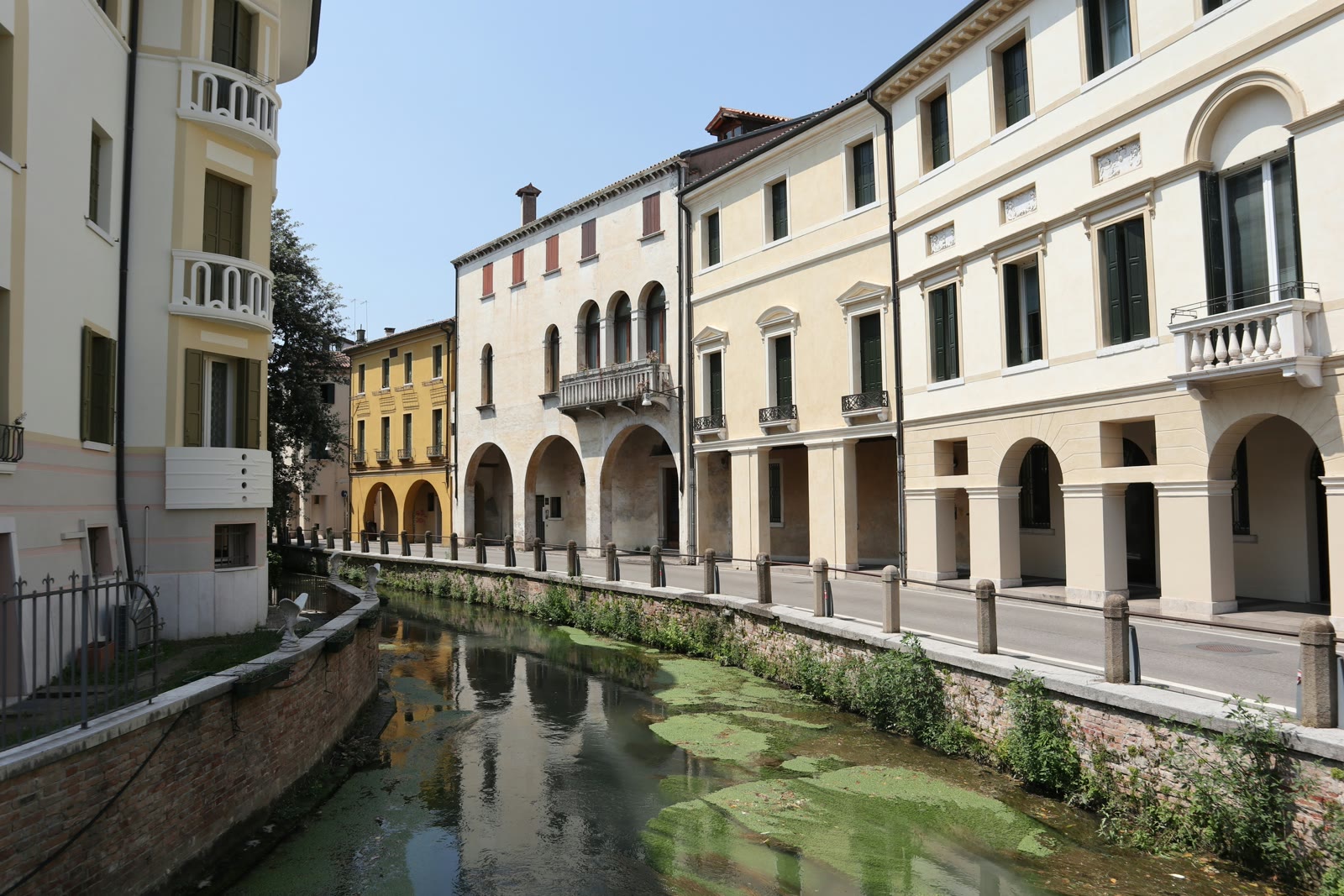 River canal flowing through the city with buildings in Treviso, Veneto, Italy