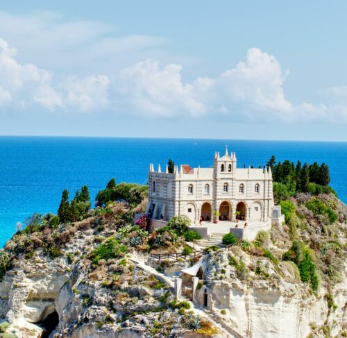 White and brown buildings on cliff near the sea in Tropea, Calabria, Italy