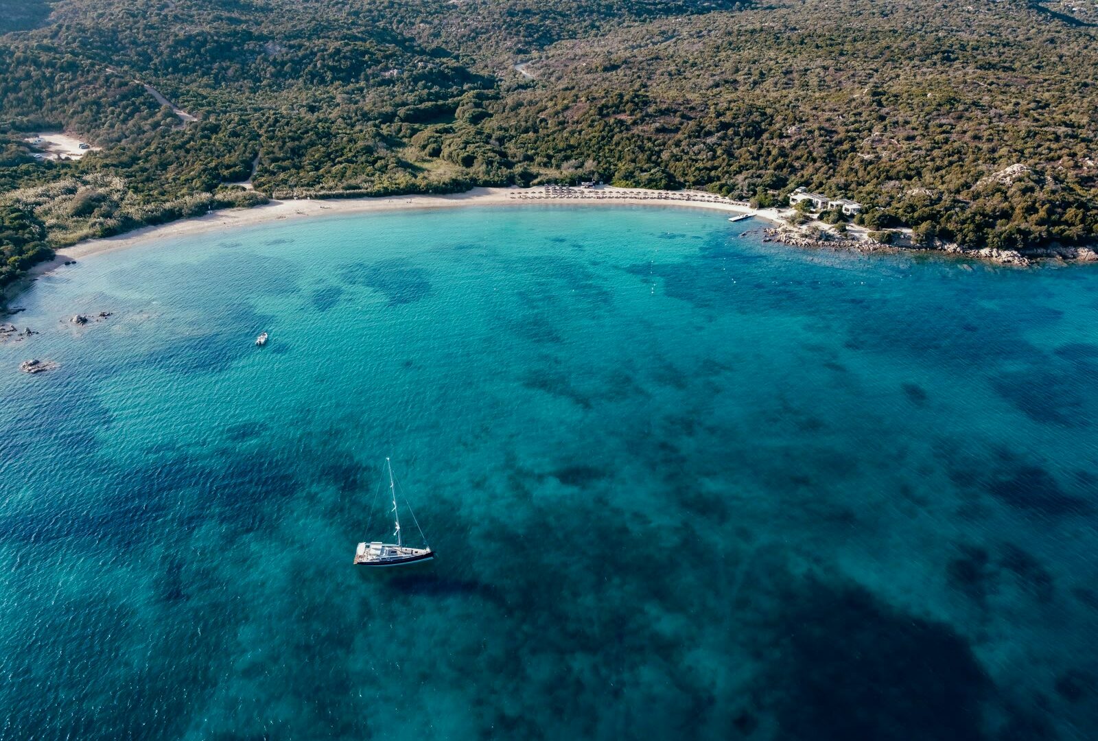 Aerial view of a boat on the water in Costa Smeralda, Sardinia, Italy