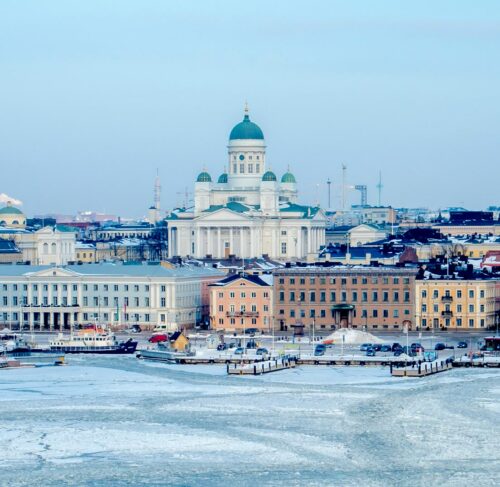 White and blue cathedral among buildings in Helsinki, Finland