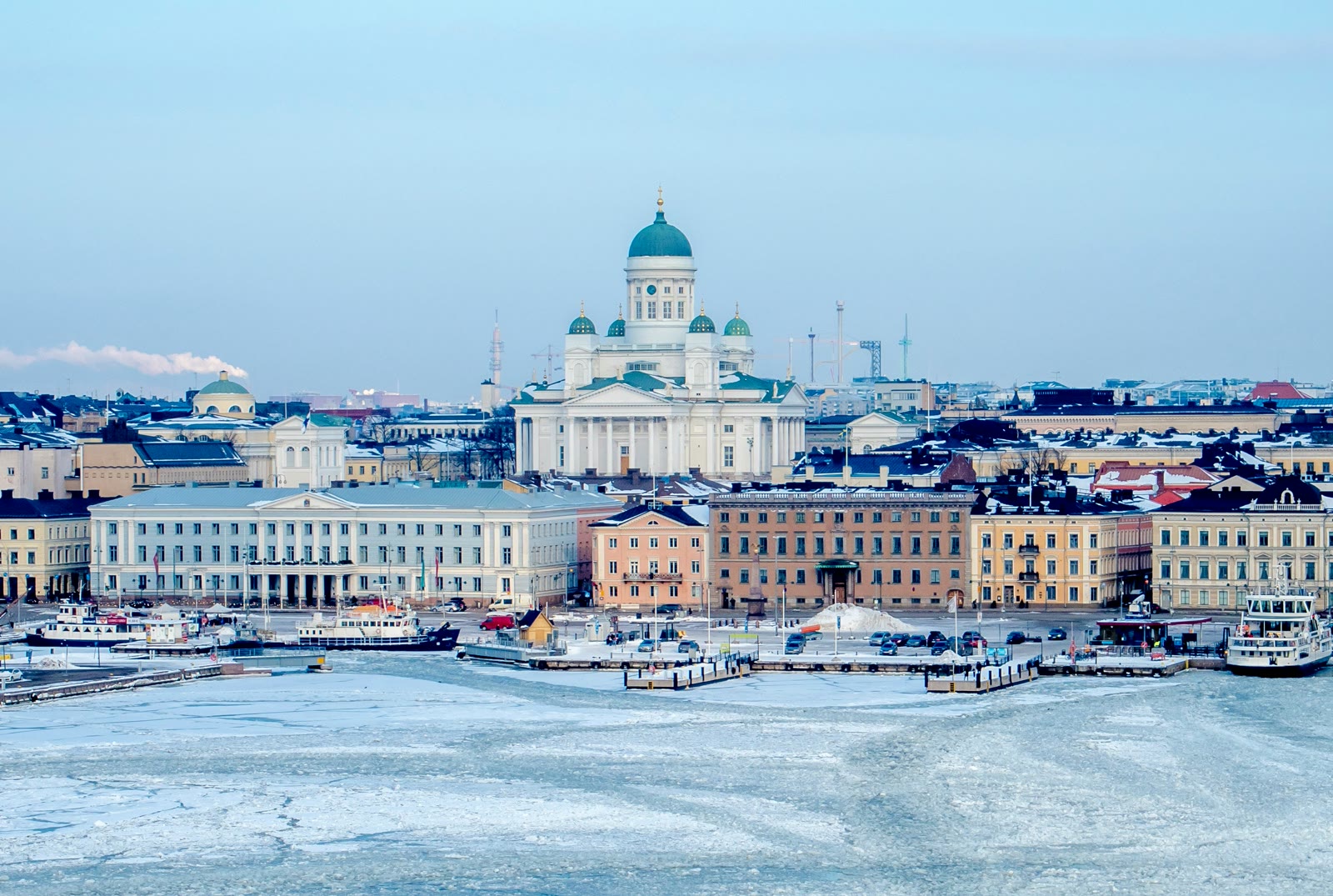White and blue cathedral among buildings in Helsinki, Finland