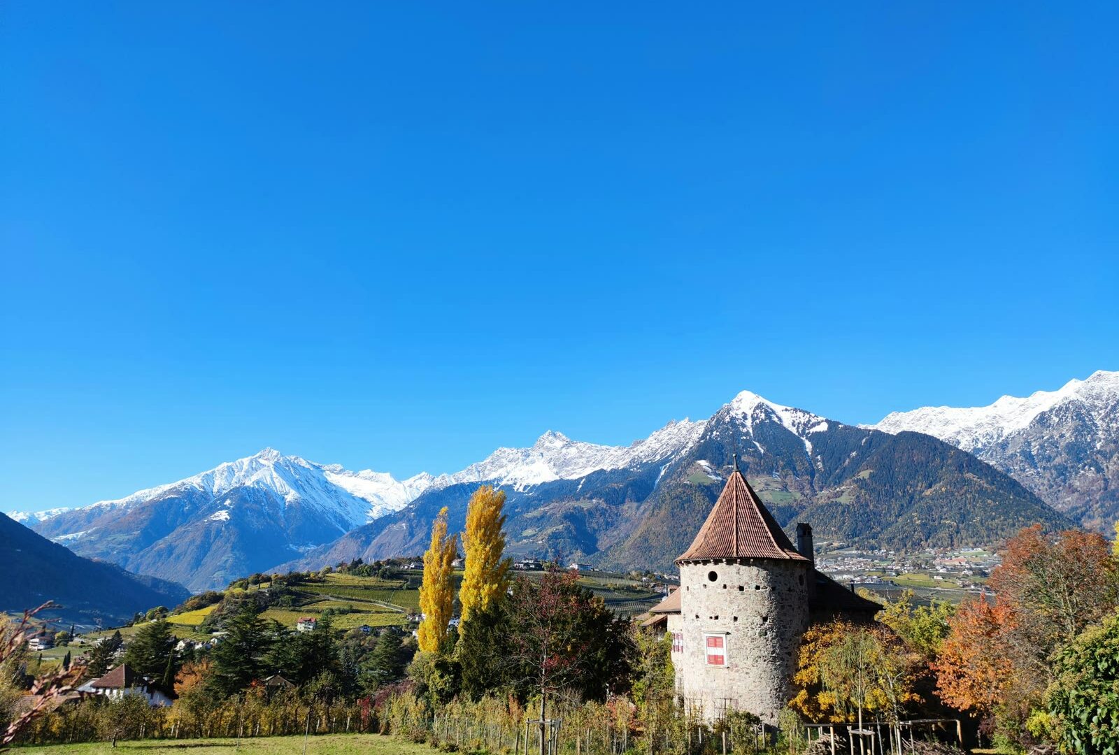 Castle in a field with mountains in background in Merano, Trentino-Alto Adige, Italy
