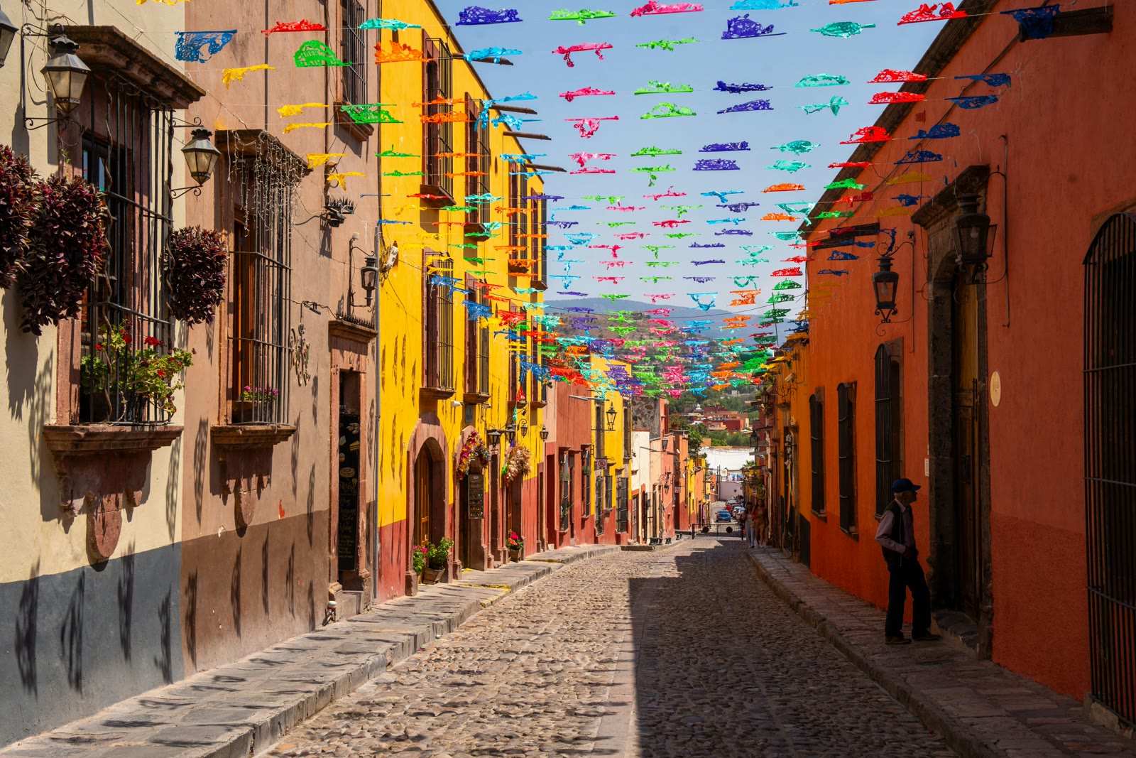 Cobblestone street lined with colorful flags in San Miguel de Allende, Guanajuato, Mexico