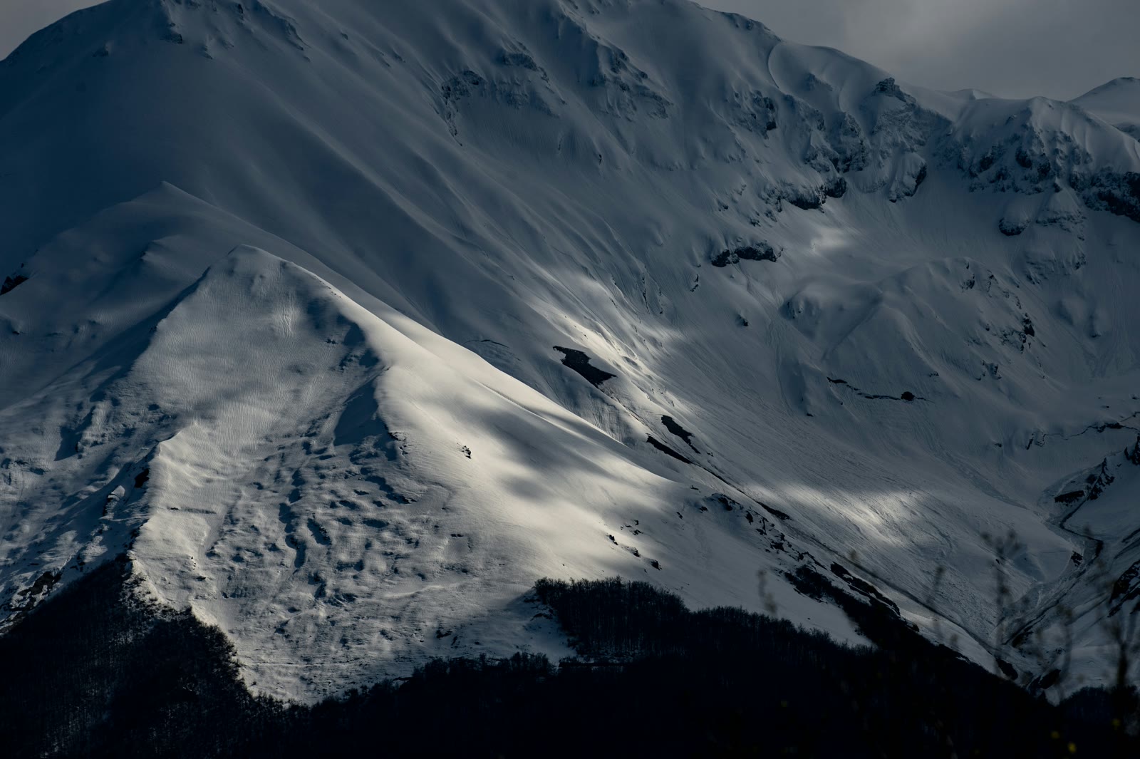 Snowy slope with dramatic shadows in Teramo, Abruzzo, Italy