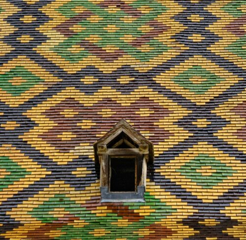 Close-up of a building with a window in Beaune, France